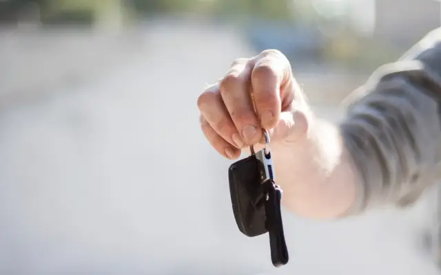 Hand holding car keys
